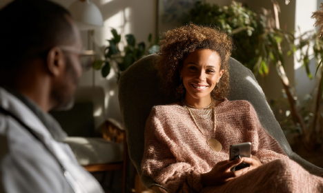 Woman speaking with her doctor while holding a phone